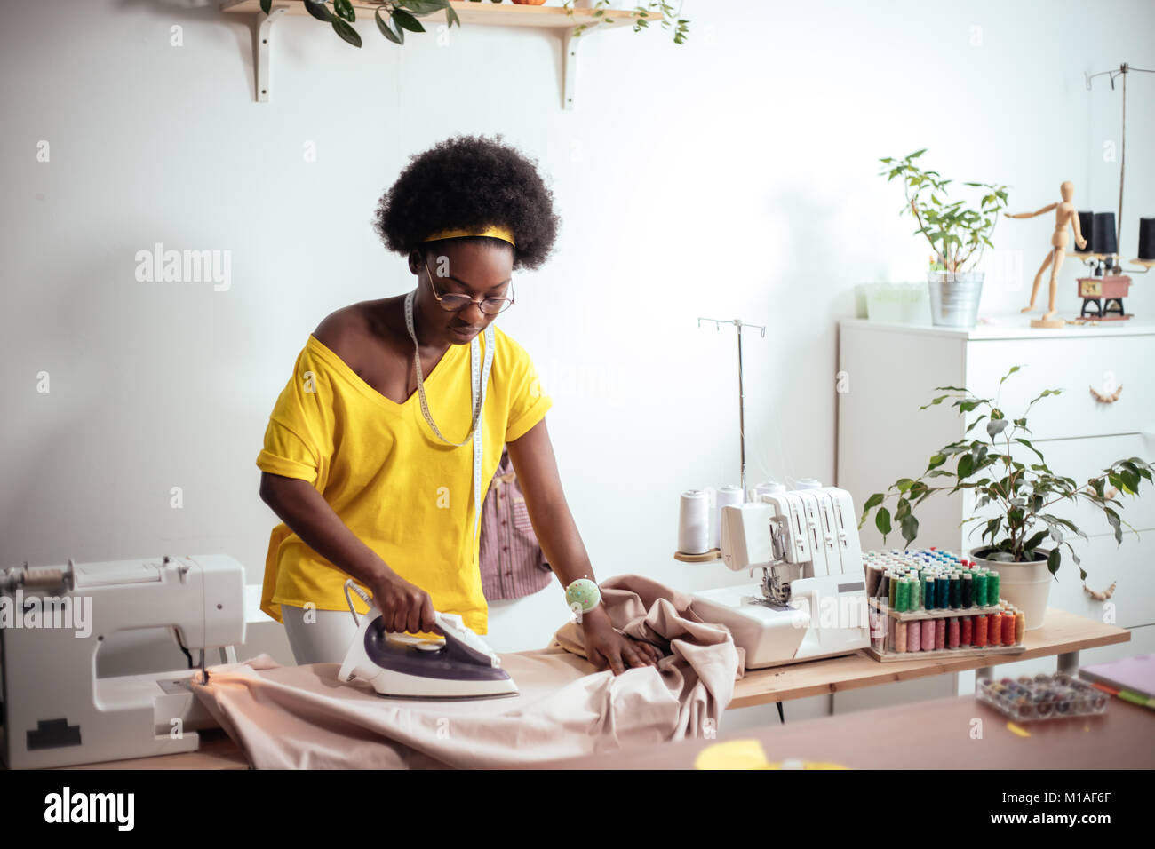 african Woman seamstress Ironing cloth Stock Photo