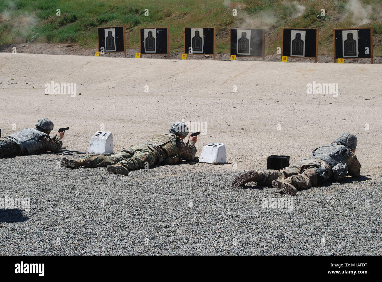 Soldiers from the 49th MP Brigade fire their M9 pistols at the firing range April 21 at Camp Roberts. (Photo by Capt. Jason Sweeney) Stock Photo