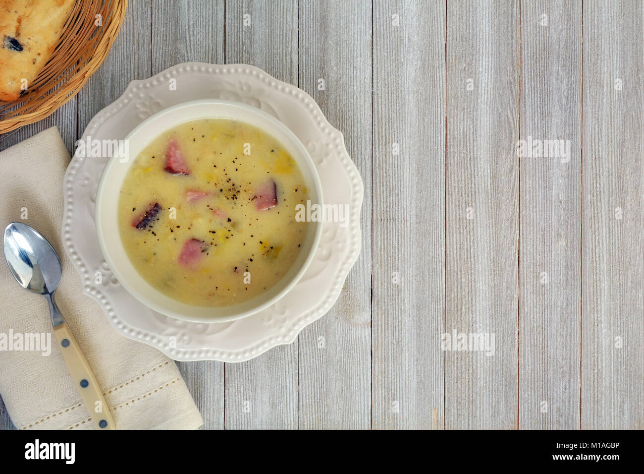 Hearty leek and potato soup with ham and cibatta bun.  Shot from overhead with copy space. Stock Photo