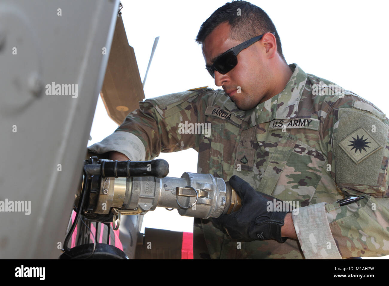 Pfc. Vicente Garcia from Echo Company, 1st Battalion, 140th Aviation Regiment, California Army National Guard, pumps fuel into a UH-60 Black Hawk July 13 at Coalinga Municipal Airport, Fresno County, California, as CalGuard air assets were called to battle the Garza Fire in mid-July 2017. (Army National Guard photo/Staff Sgt. Eddie Siguenza) Stock Photo