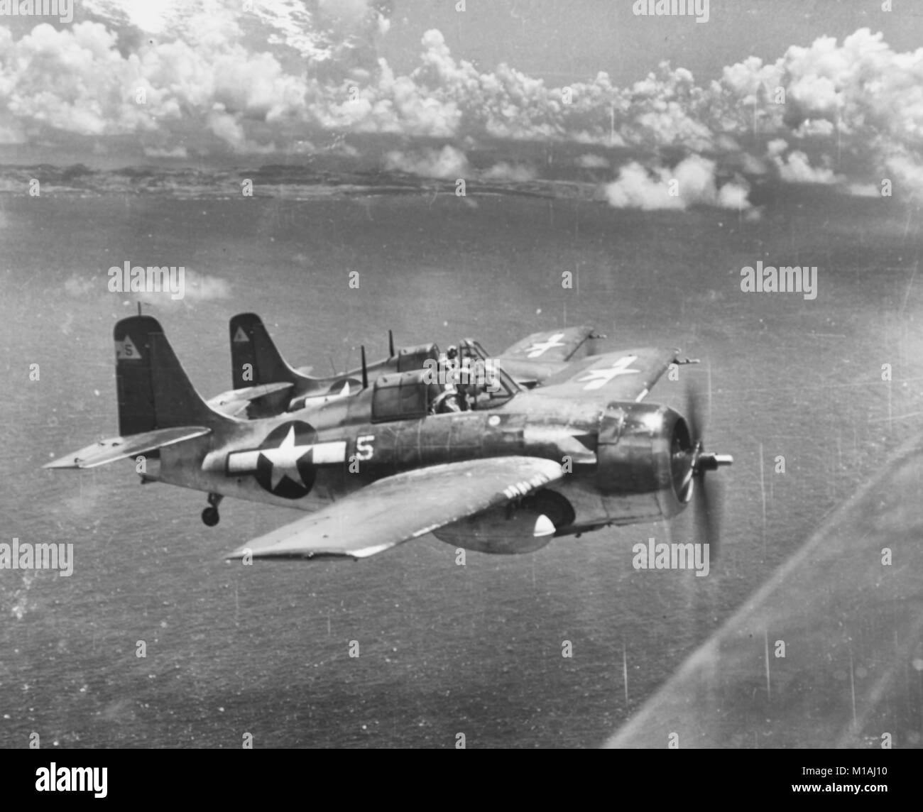General Motors FM-2 'Wildcat' fighters - General Motors FM-2 Wildcat fighters From USS White Plains (CVE-66), fly an escort mission, probably during air strikes on Japanese facilities on Rota Island, Marianas, 24 June 1944. Stock Photo