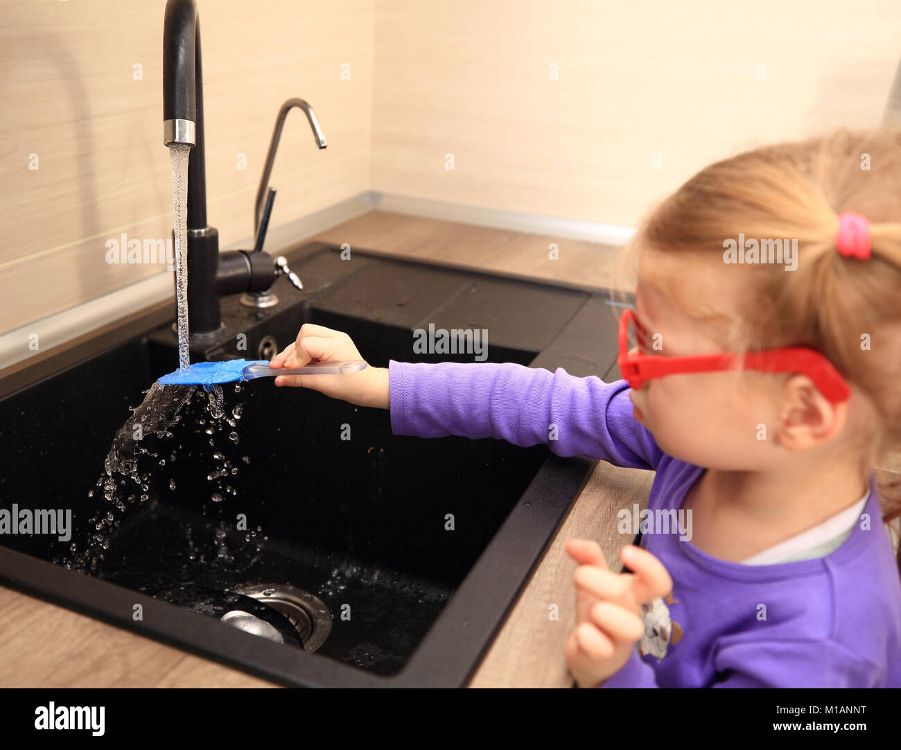Little girl washing kitchen items by hand Stock Photo Alamy