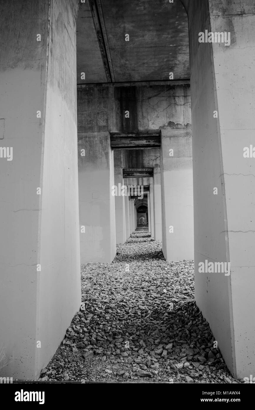 Under railway bridge in port adelaide, moody image black and white Stock Photo