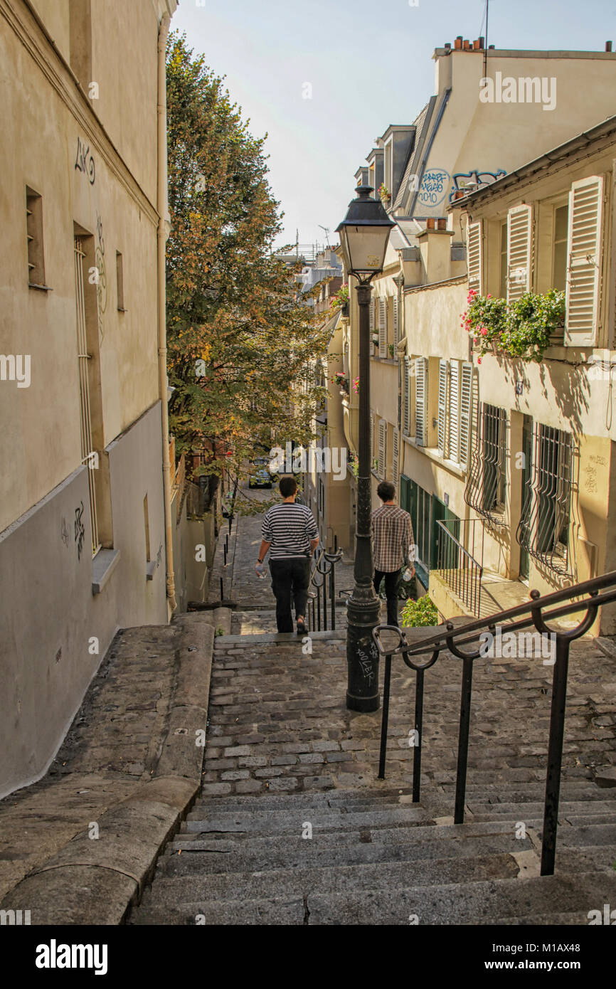 Boys walking down steps in Montmarte, Paris Stock Photo