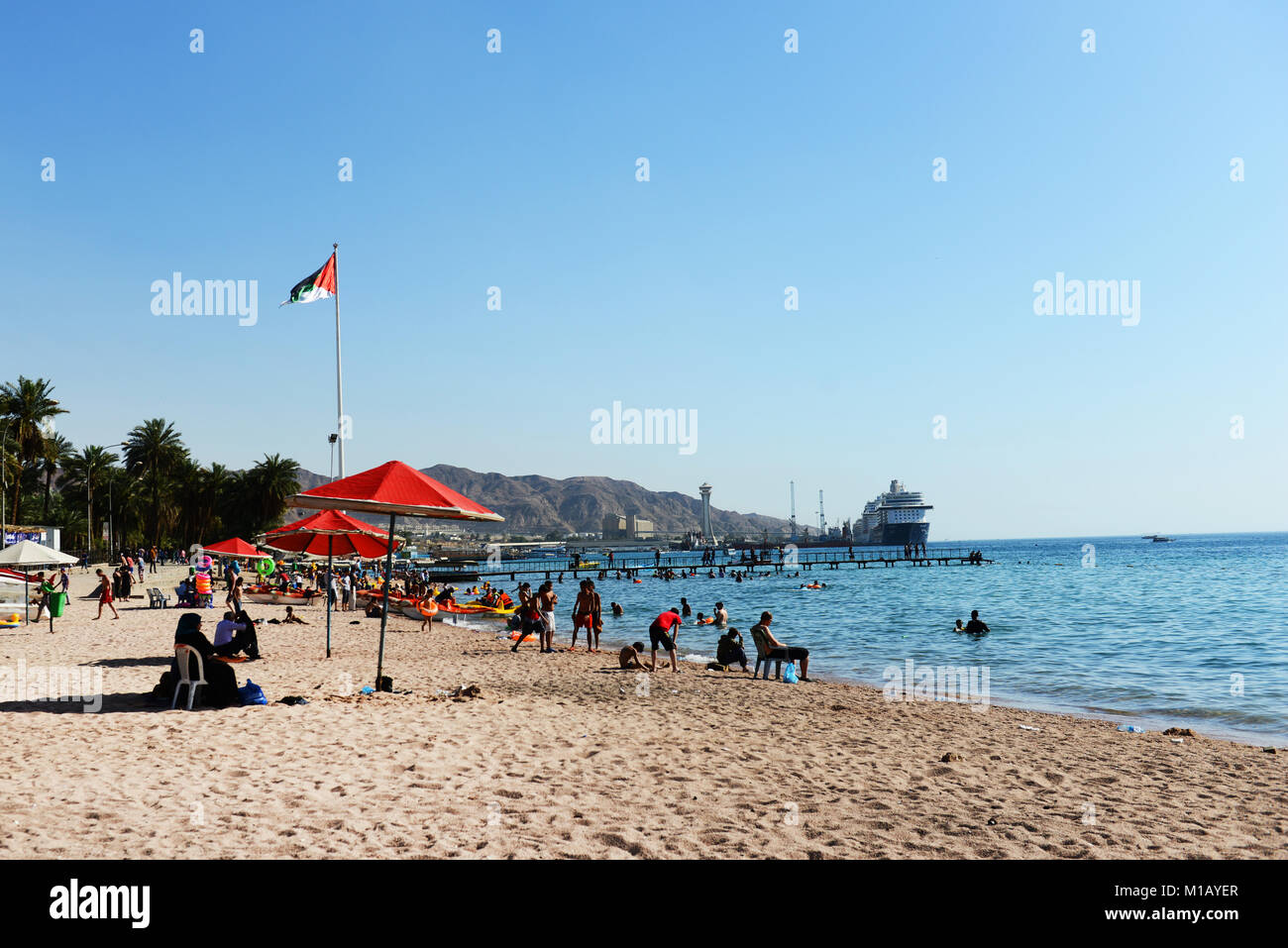 Jordanians and tourist having a good time on Al-Ghandour Beach in Aqaba, Jordan. Stock Photo