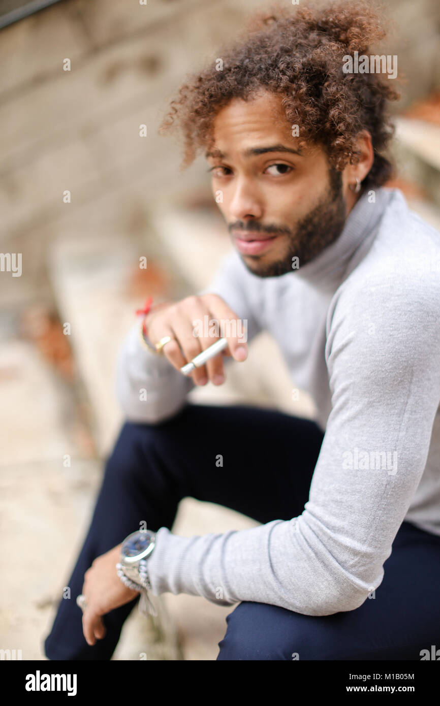 Young smoker coughing on steps with cigarette Stock Photo Alamy