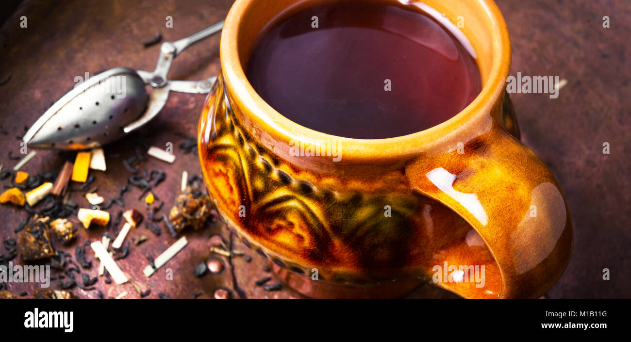 Clay cup with herbal tea on a vintage background Stock Photo