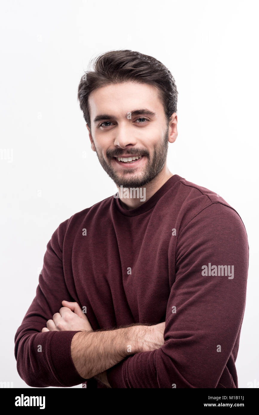 Pleasant handsome man folding arms across his chest Stock Photo