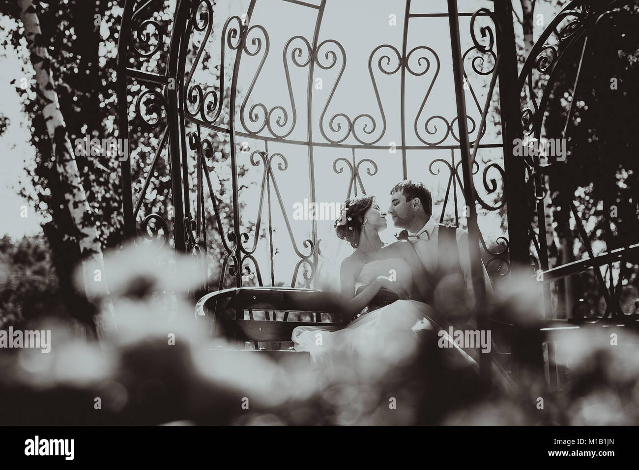 the bride and groom in the gazebo in the park Stock Photo - Alamy