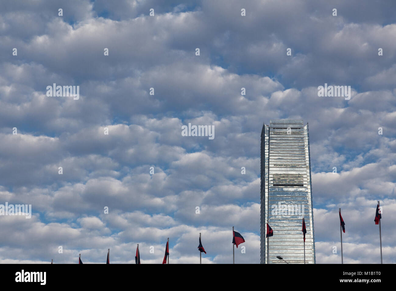 International Commerce Center, tower above flags in Hong Kong, China. Stock Photo