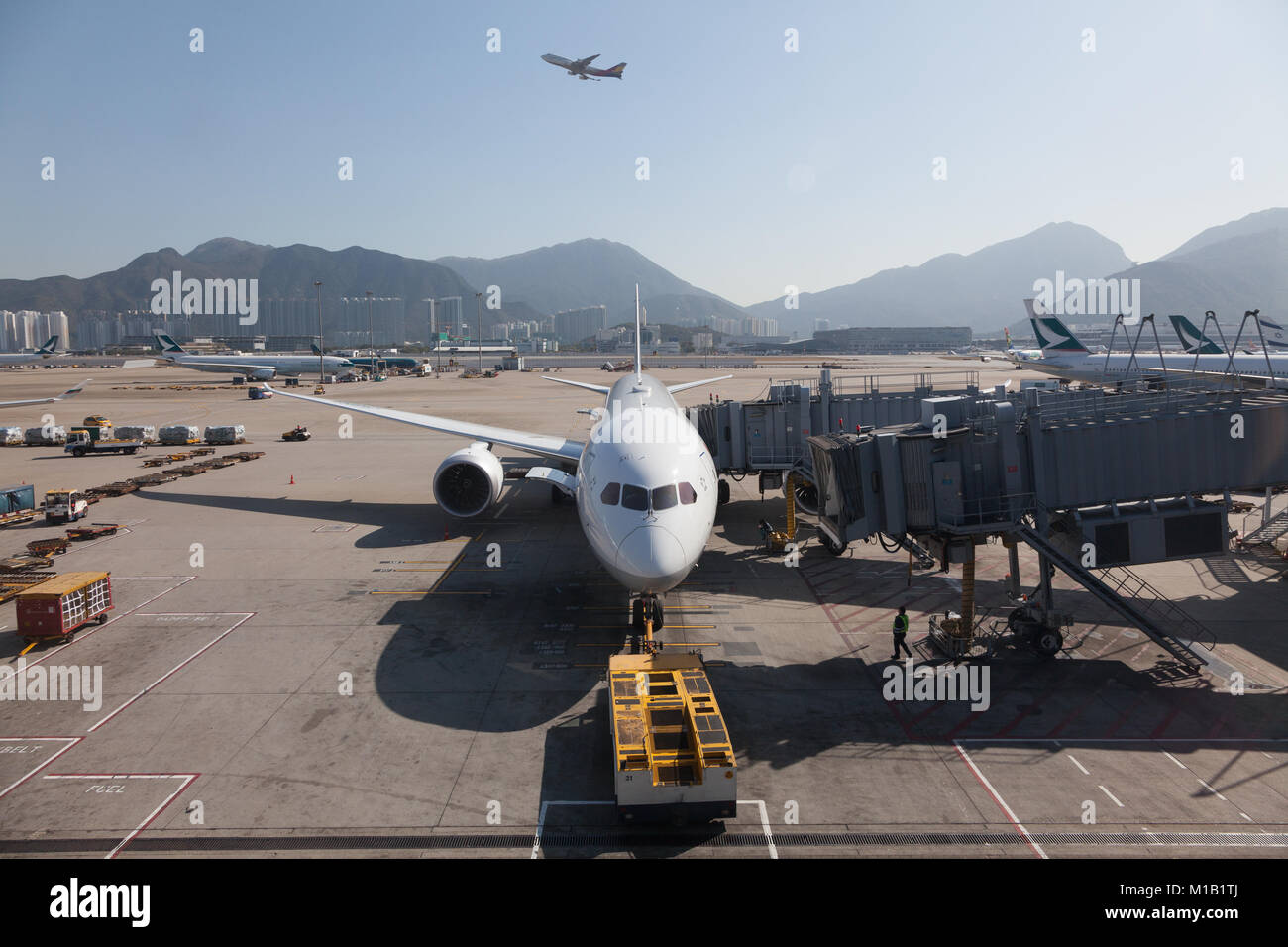 Airliners on the apron and taking off from Chek Lap Kok Airport, Hong Kong SAR, China. Stock Photo