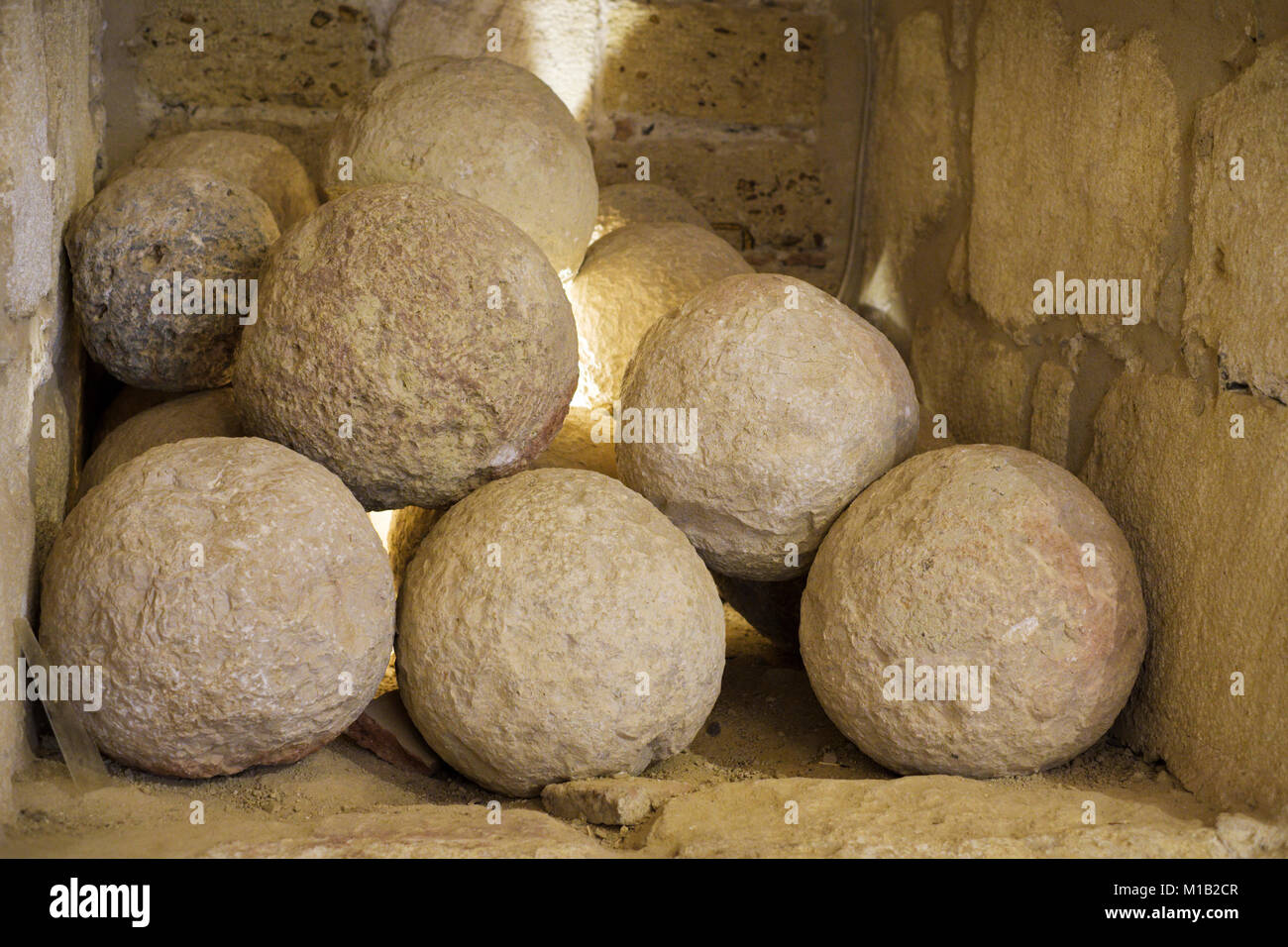 Stone cannon balls in the armoury guardroom, Torre de Homenaje, Alcazaba of Antequera, Antequera, Andalusia, Spain Stock Photo
