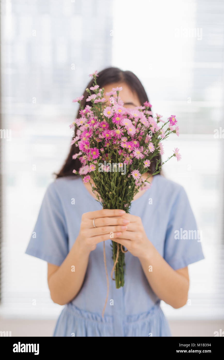 Studio shot of happiness woman receiving pretty flowers Stock Photo