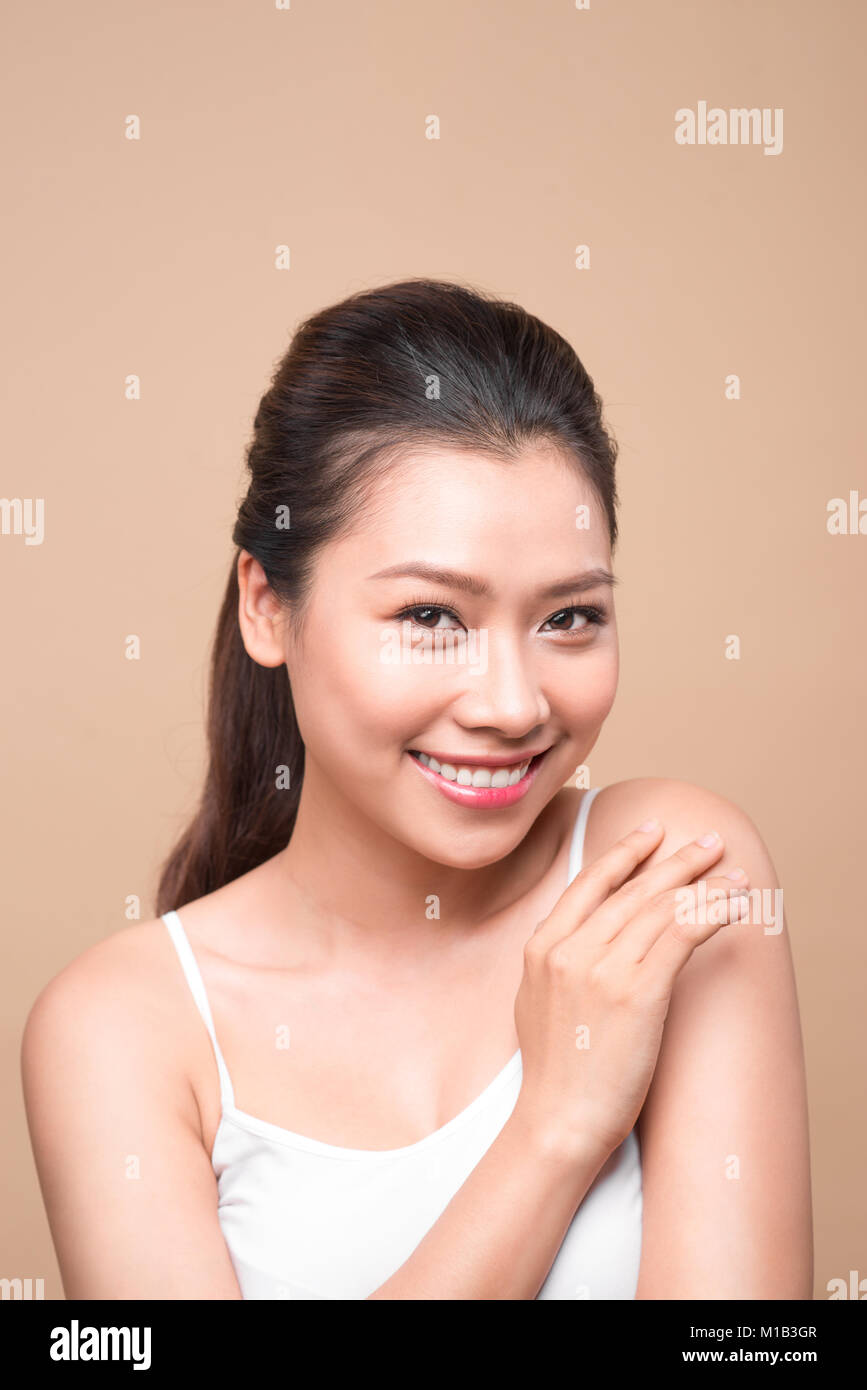 Clean fresh skin concept. Young asian woman touching her shoulder Stock ...