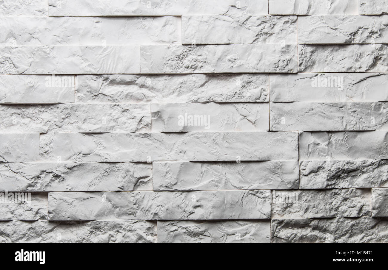 White textured brick background. Decorative brick for wall. Brick wall in gradient studio light. Stock Photo