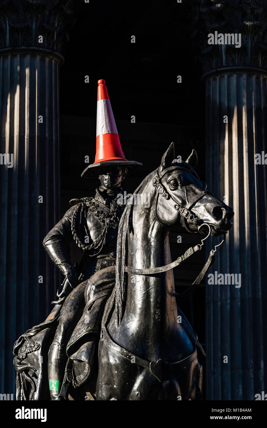 Statue of Wellington on horseback with traffic cone on his head at