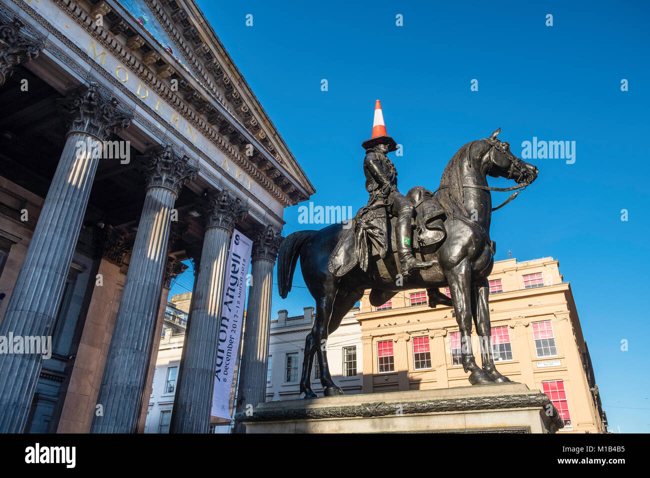 Statue of Wellington on horseback with traffic cone on his head at Gallery of Modern Art in Exchange Square, Glasgow, United Kingdom Stock Photo