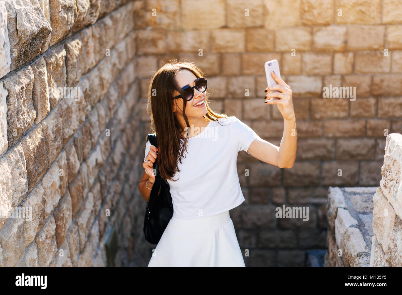 Happy young woman taking selfie Stock Photo - Alamy