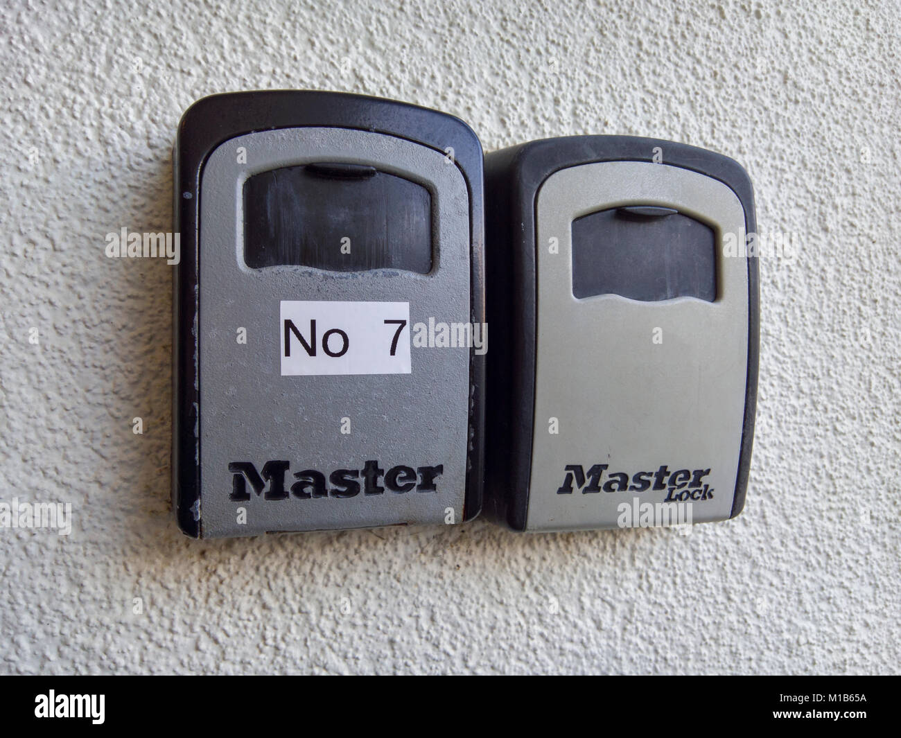 A pair of Master Lock combination key safes outside apartments. Stock Photo