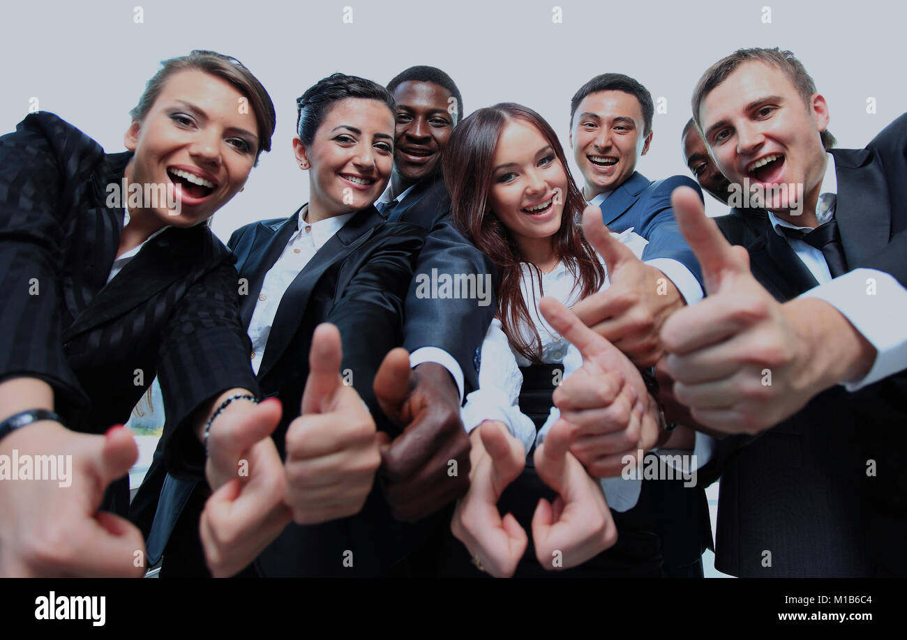 Successful business people with thumbs up and smiling Stock Photo - Alamy