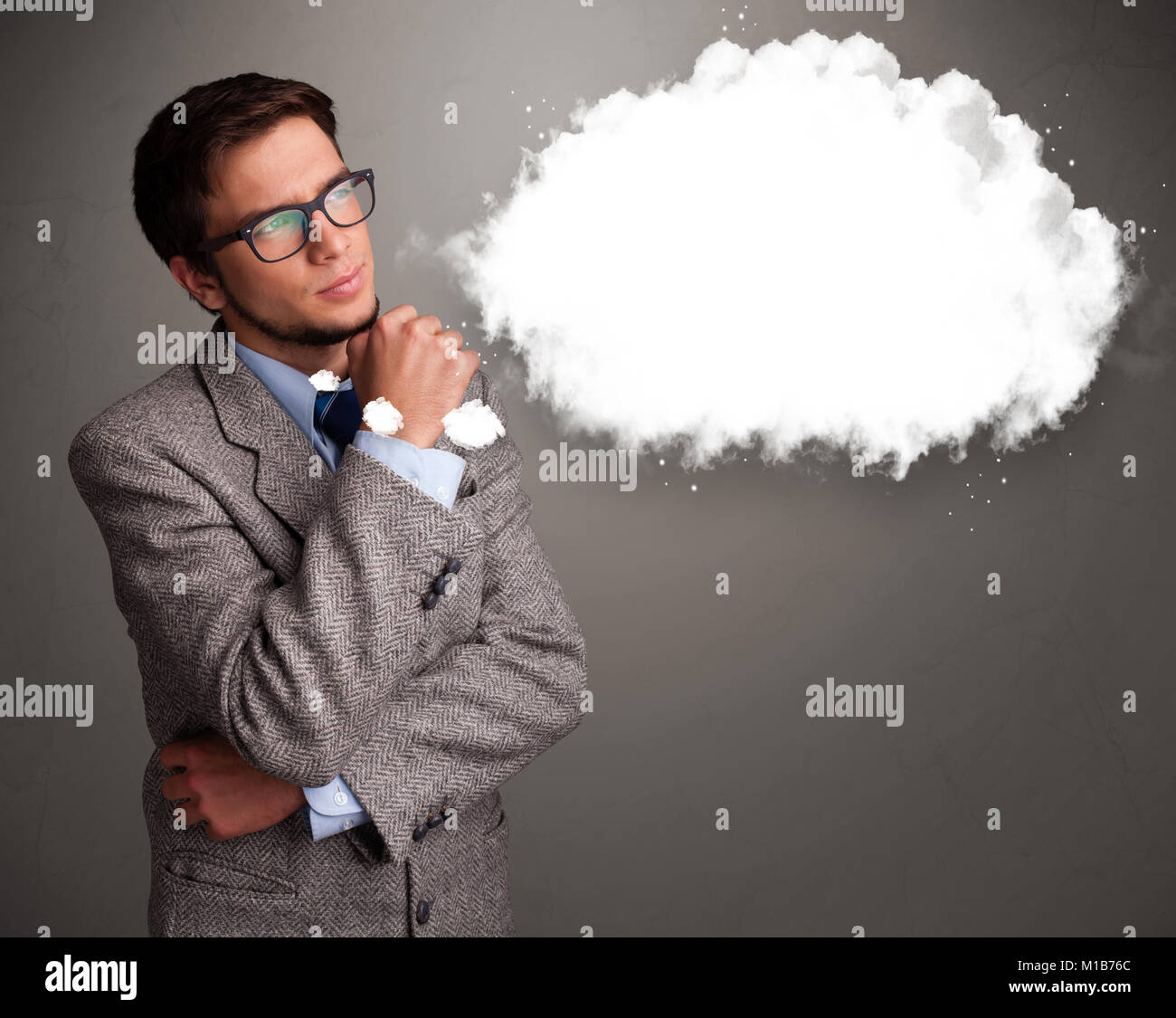 Good-looking young man thinking about cloud speech or thought bubble with copy space Stock Photo