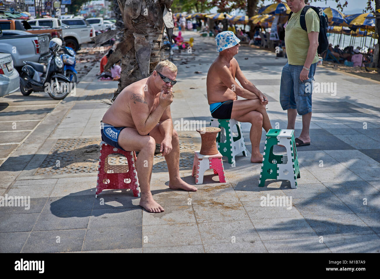 Smokers confined to the Thailand sidewalk following the introduction of a beach smoking ban. Pattaya Southeast Asia Stock Photo