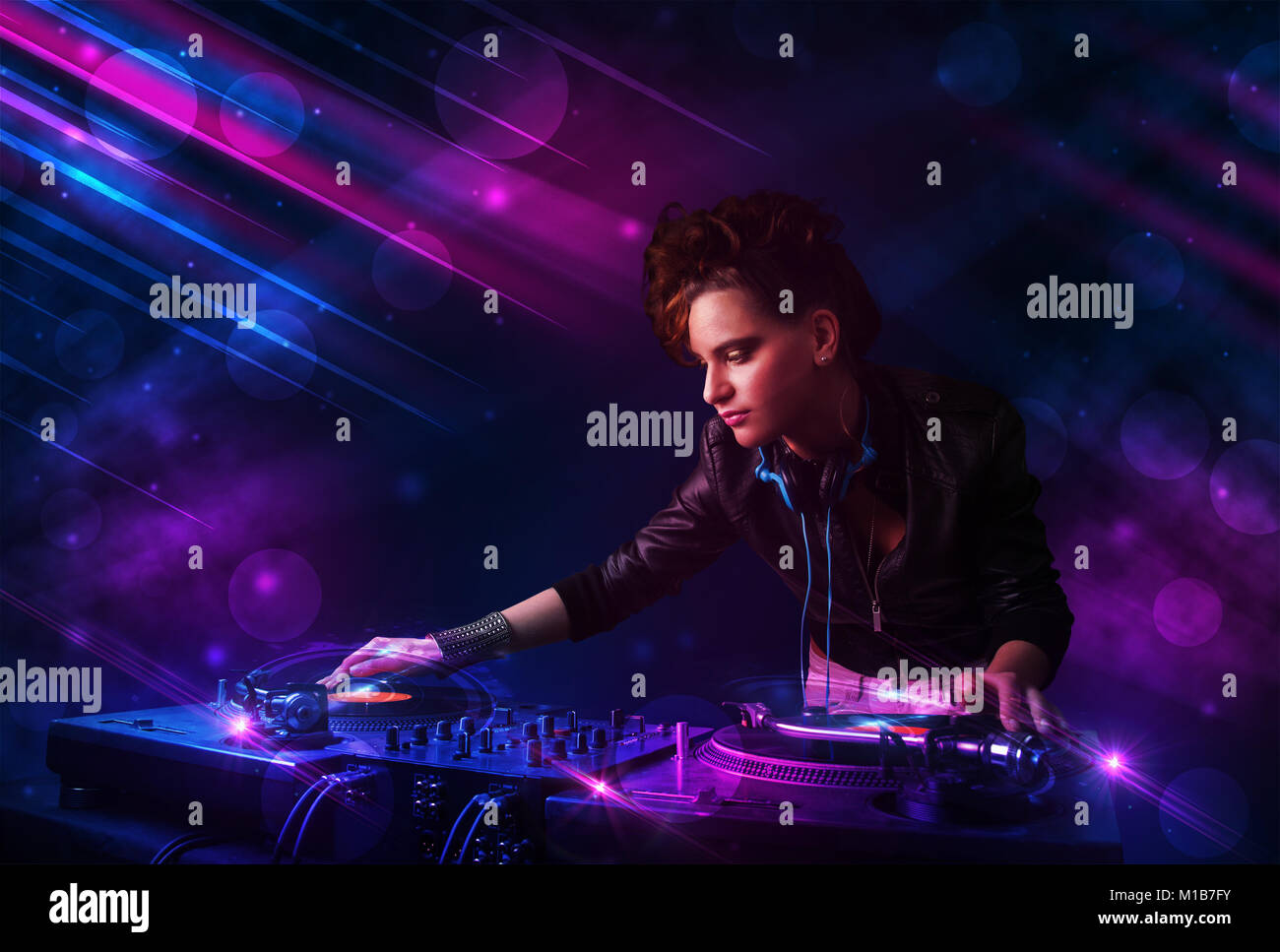 Beautiful young Dj playing on turntables with color effects Stock Photo ...