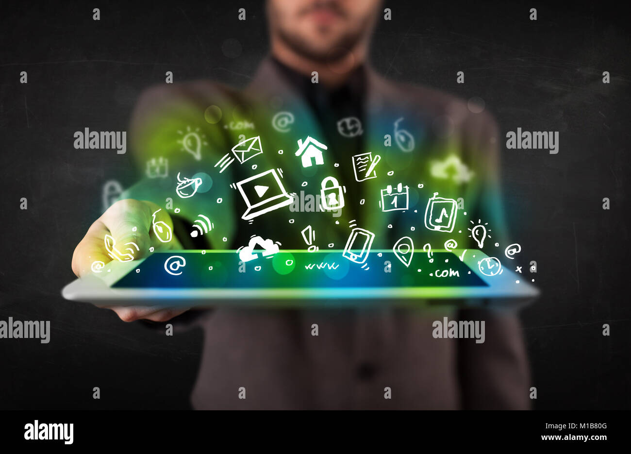 Person holding tablet pc with green media icons and symbols Stock Photo ...