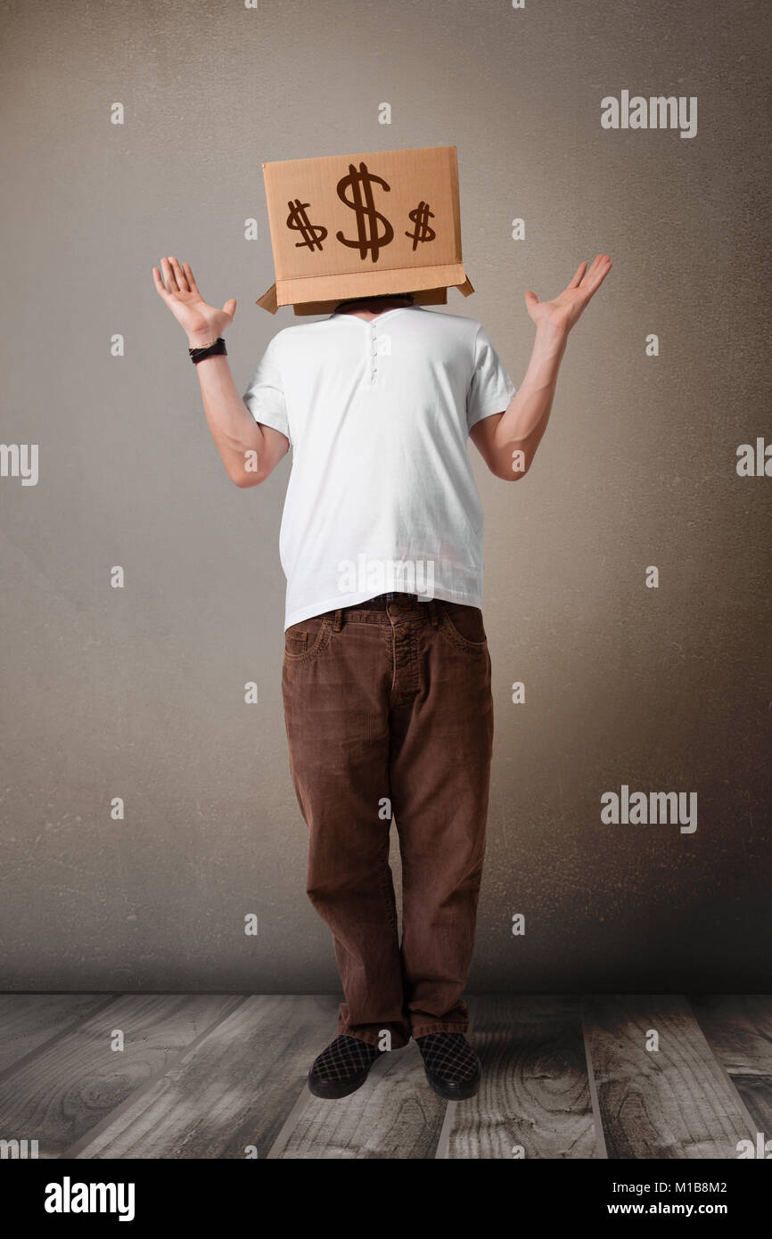 Young man standing and gesturing with a cardboard box on his head with ...