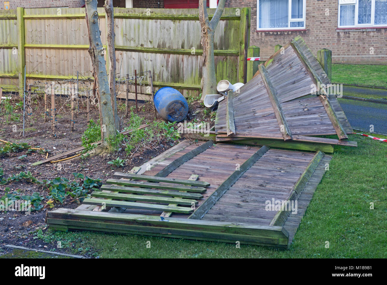 London, Lewisham  A garden fence blown down by a winter storm Stock Photo