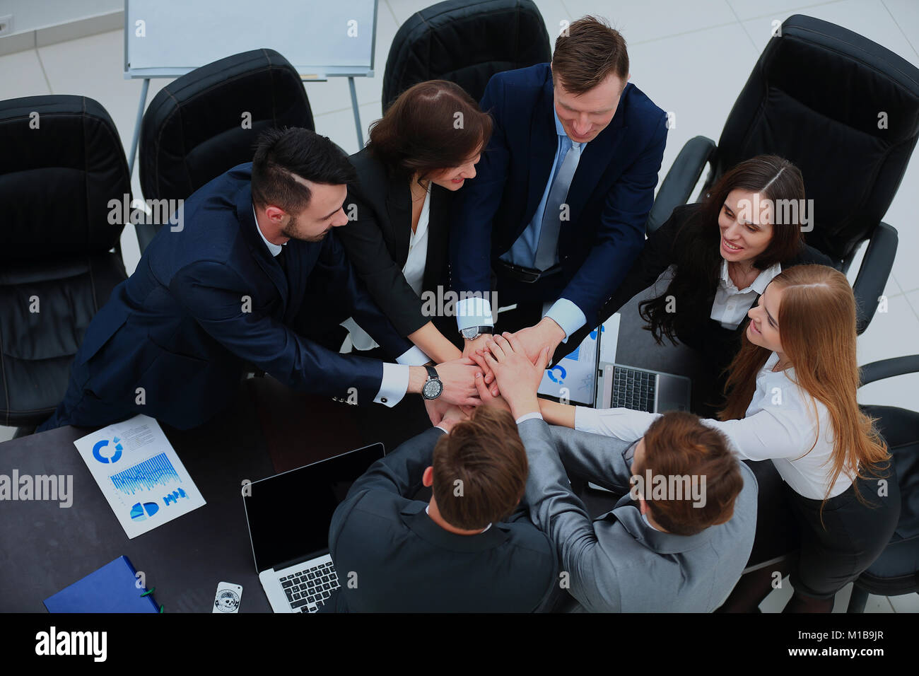 Business team showing unity with their hands together Stock Photo - Alamy