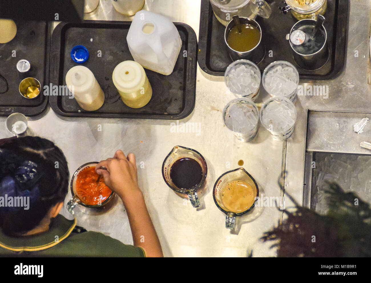 People at work behind the scene in a coffee shop kitchen Stock Photo