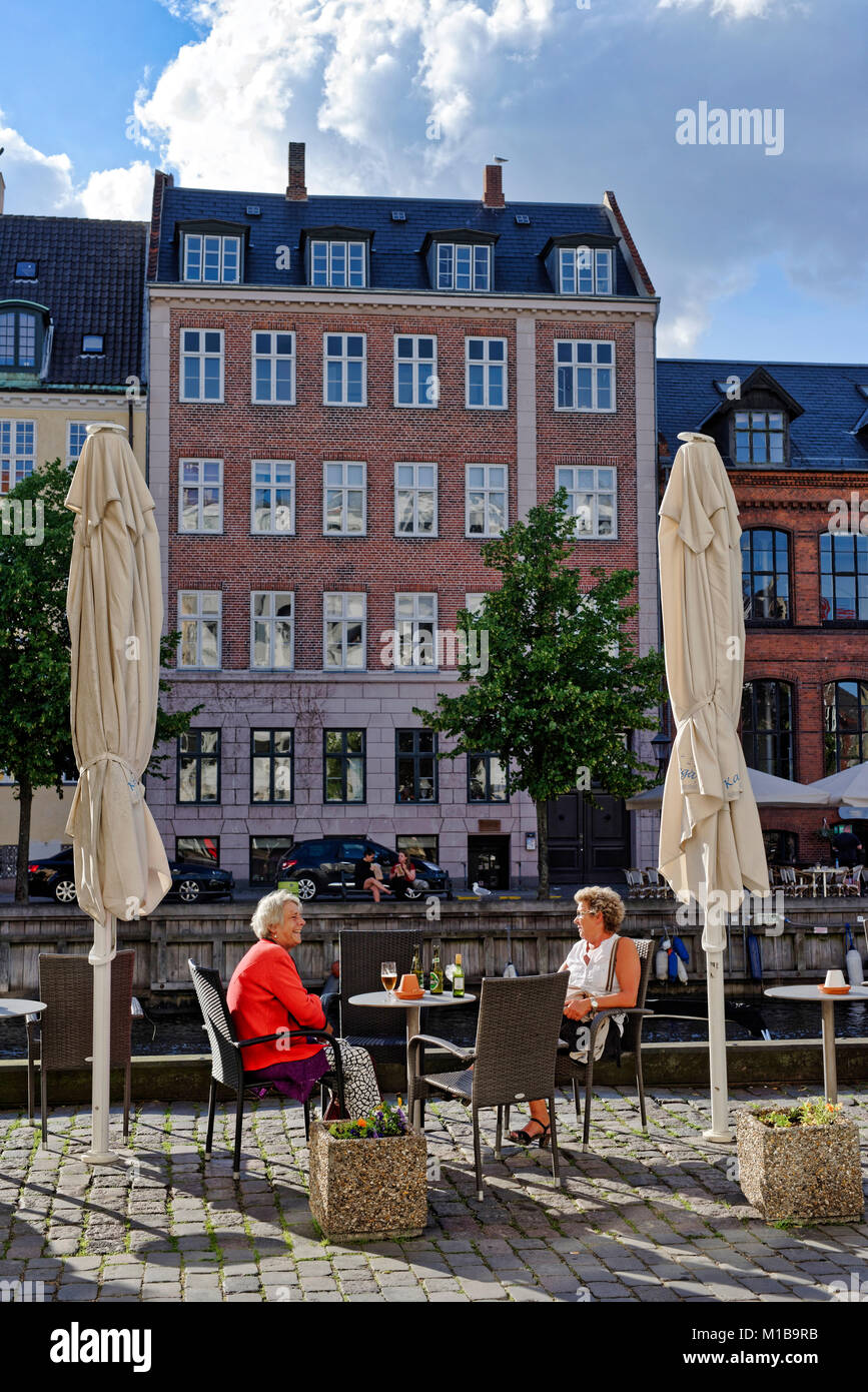 Two middle aged women having a drink in Copenhagen Stock Photo - Alamy