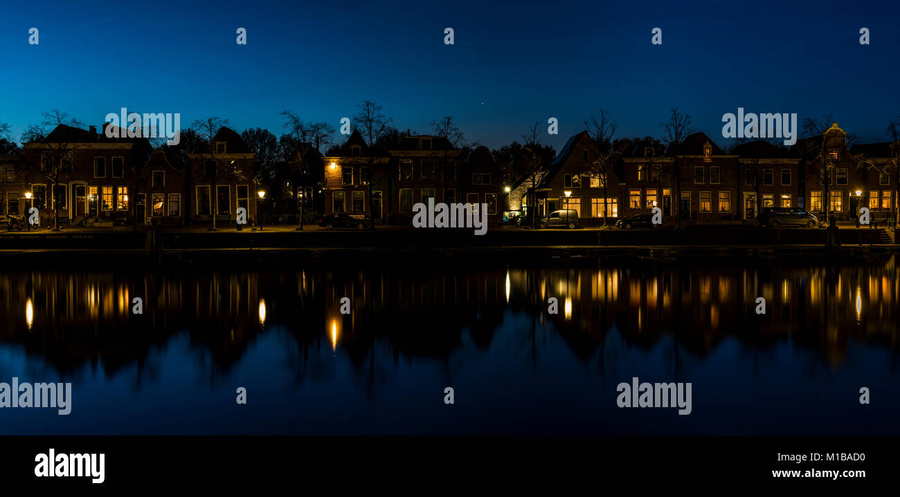 Blokzijl, The Netherlands - November 24, 2016:  A street (Noorderkade) at the harbor in Blokzijl at night in Overijssel, Netherlands. Stock Photo