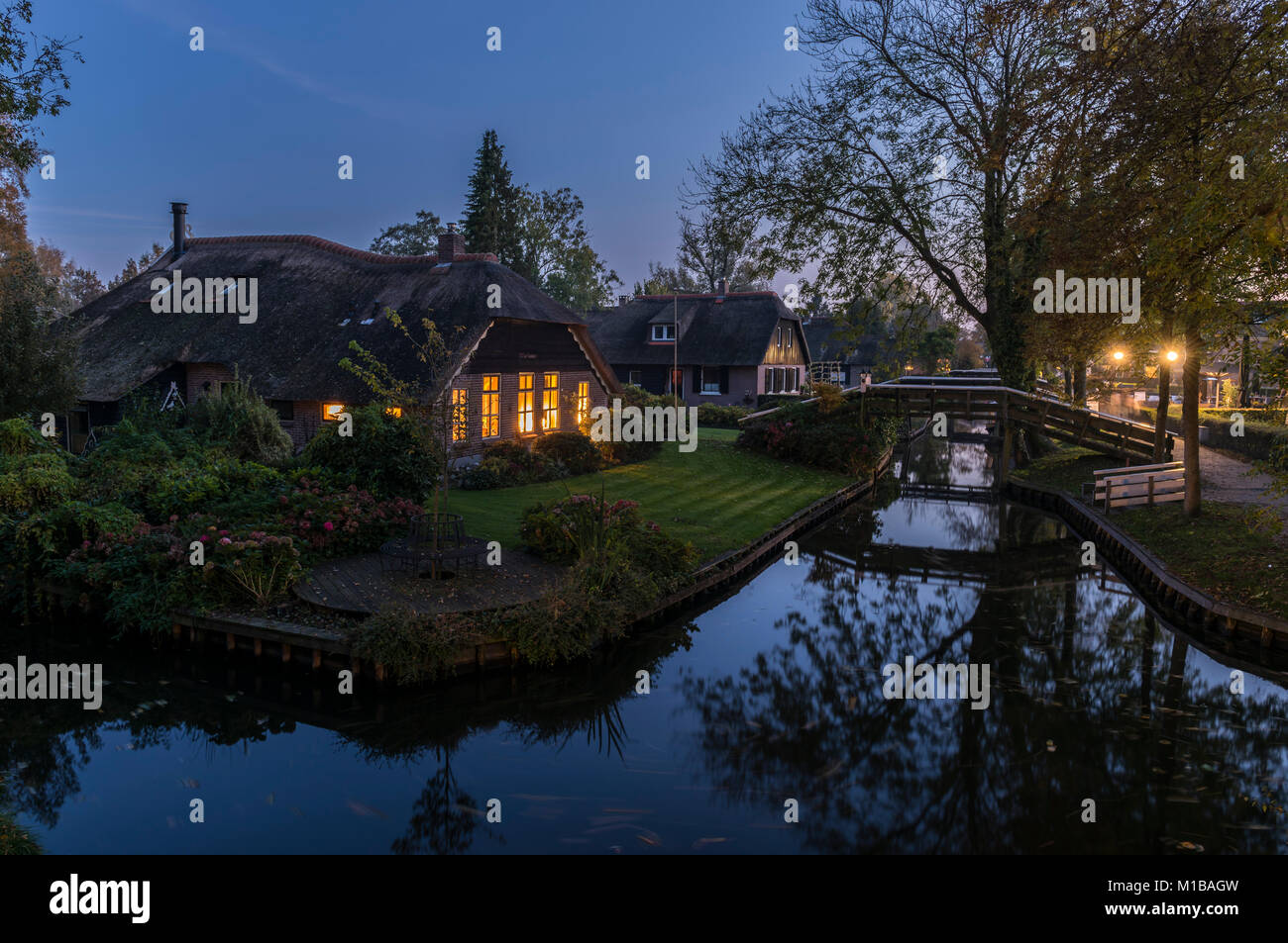 Giethoorn, The Netherlands - October 31, 2016:  Autumn evening inthe small village of Giethoorn in Overijssel, Netherlands with monumental farms and w Stock Photo