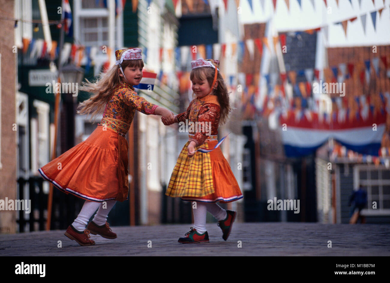 The Netherlands. Marken. Kingsday 27 April. Children dancing in traditional costume. Stock Photo