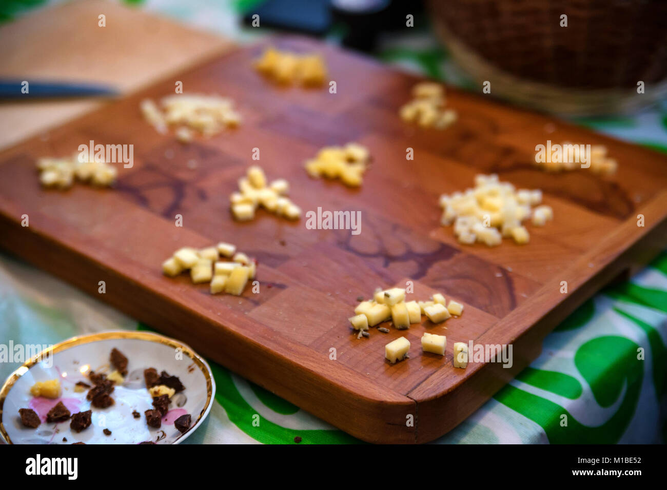 Close up small cheese crumbles for tasting on wooden board Stock Photo