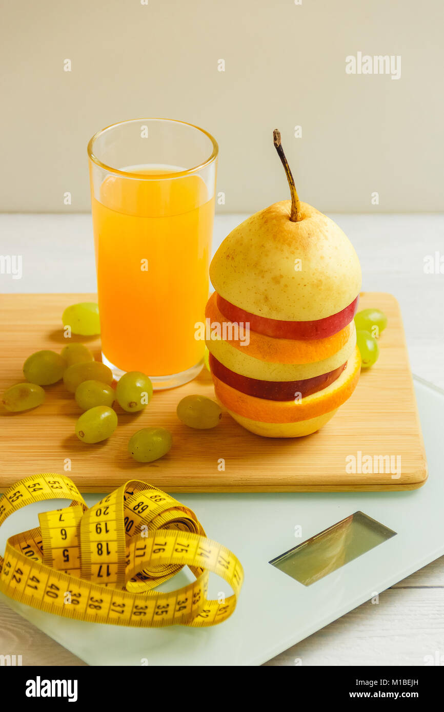 floor scale and fruits on wooden background Stock Photo