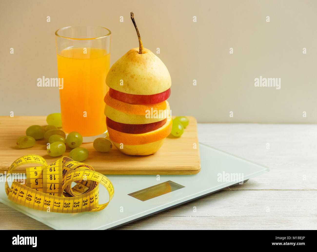 floor scale and fruits on wooden background Stock Photo