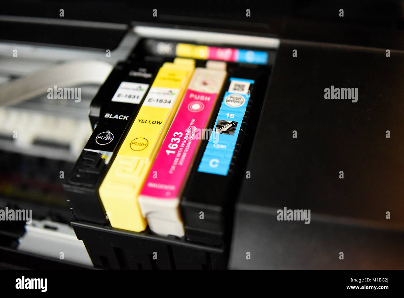 Printer ink cartridges in printer. Mixed budget replacement cartridges in  carrier of Epson WF-2630 Stock Photo - Alamy