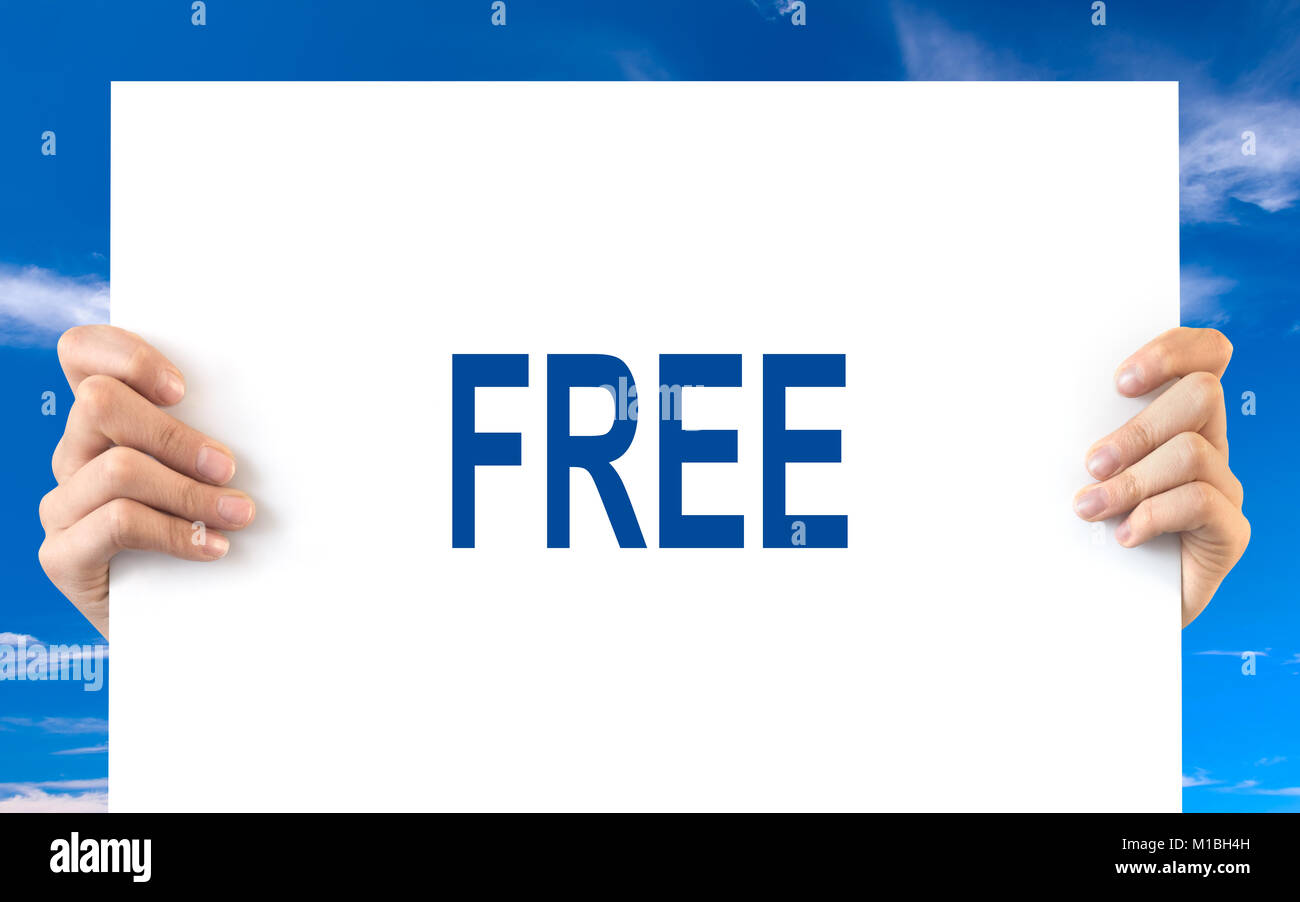 Hands holding a white board with the word free, blue sky background Stock Photo