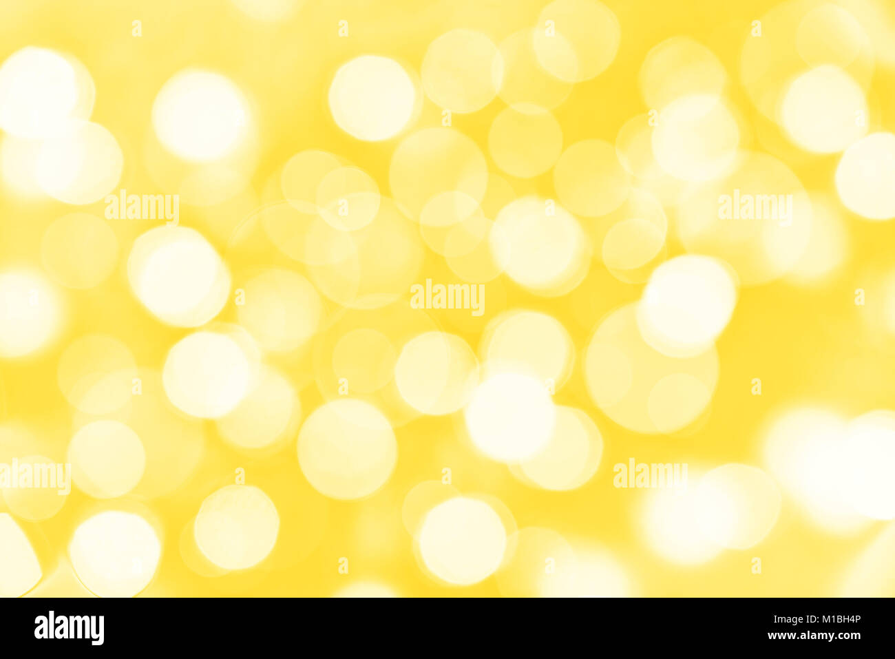 Holiday golden background with blurred bokeh lights Stock Photo