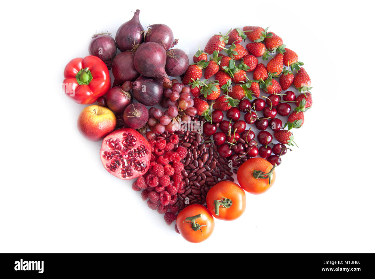 Red fruits, vegetables and pulses in the shape of a heart Stock Photo