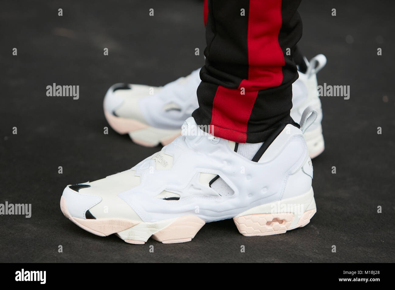 MILAN - JANUARY 15: Man with white Reebok Insta pump shoes and black  trousers with red stripe at Pal Zileri before fashion show, Milan Fashion  Week st Stock Photo - Alamy