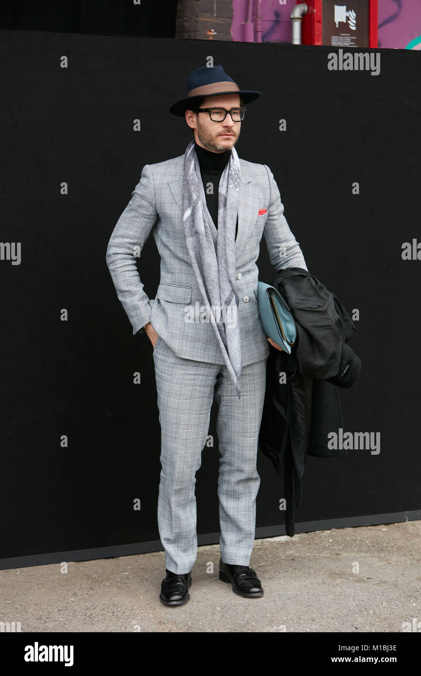 MILAN - JANUARY 15: Man with gray suit before Pal Zileri fashion show, Milan Fashion Week street style on January 15, 2018 in Milan. Stock Photo