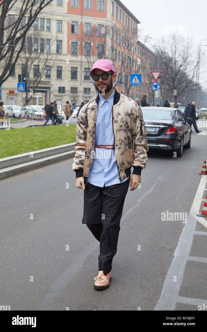 MILAN - JANUARY 15: Man with beige bomber jacket and pink cap before Giorgio Armani fashion show, Milan Fashion Week street style on January 15, 2018  Stock Photo