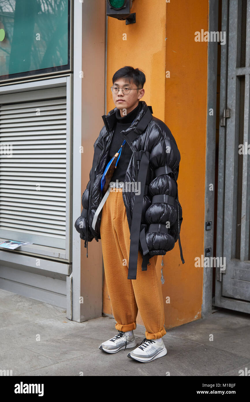 MILAN - JANUARY 15: Man with black Moncler padded jacket and yellow  trousers before Giorgio Armani fashion show, Milan Fashion Week street style  on Ja Stock Photo - Alamy