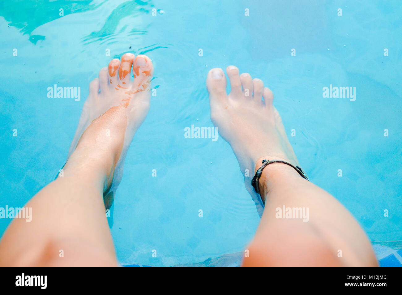Relaxing feet soaking in the hot springs of Berastagi, North Sumatra Indonesia Stock Photo