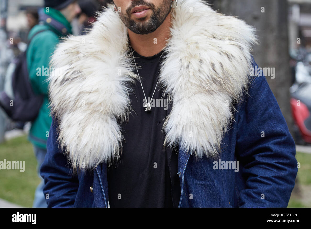 MILAN - JANUARY 15: Man with blue jeans jacket and white fur collar before Giorgio Armani fashion show, Milan Fashion Week street style on January 15, Stock Photo