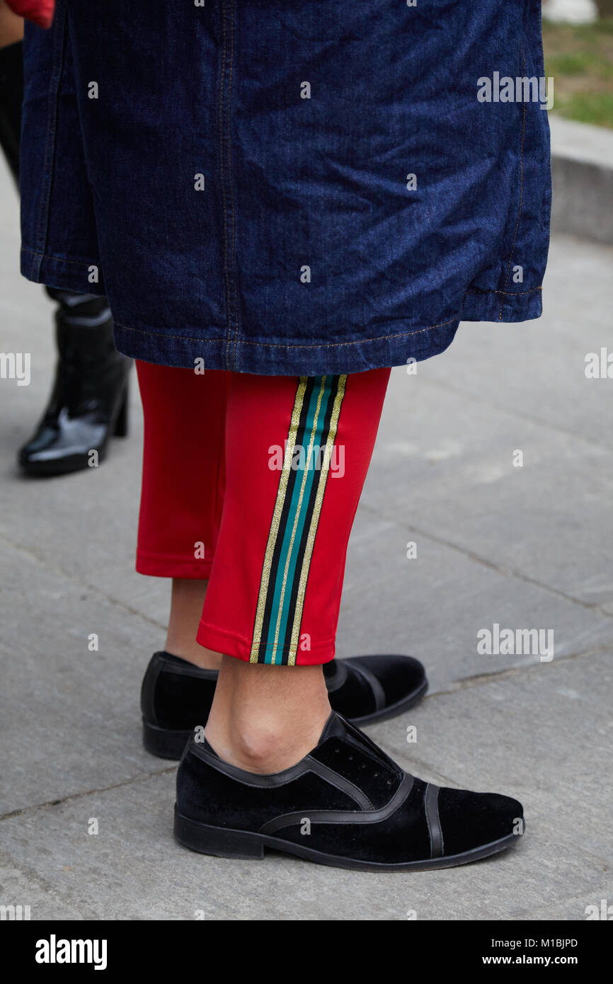 MILAN - JANUARY 15: Man with black velvet shoes, red trousers and blue jeans  jacket before Giorgio Armani fashion show, Milan Fashion Week street styl  Stock Photo - Alamy